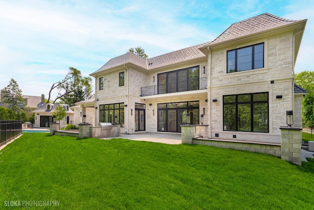 219 Lincoln Dr, Glencoe, IL 60022 - back of property featuring a balcony, a lawn, a patio, and stone siding