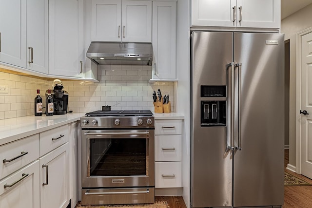 962 Thompson Blvd, Buffalo Grove, IL 60089 - kitchen with appliances with stainless steel finishes, range hood, light countertops, tasteful backsplash, and white cabinetry