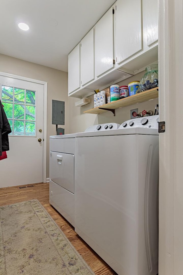 962 Thompson Blvd, Buffalo Grove, IL 60089 - laundry room featuring washer and dryer, electric panel, cabinet space, and light wood finished floors
