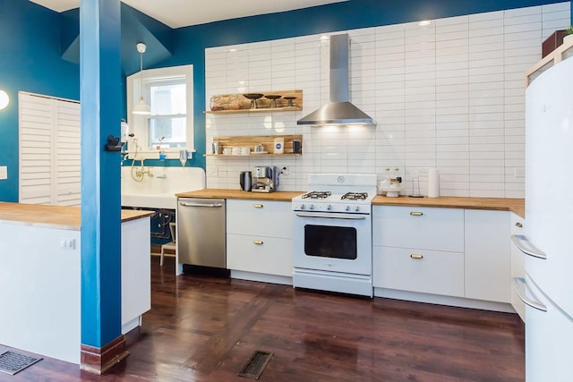2340 W 19th St, Chicago, IL 60608 - kitchen with white appliances, butcher block countertops, wall chimney exhaust hood, tasteful backsplash, and white cabinets