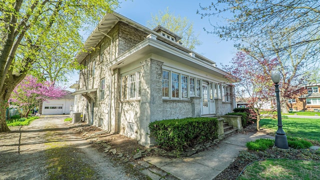 531 E Joliet St, Crown Point, IN 46307 - view of side of property featuring a central air condition unit and stucco siding