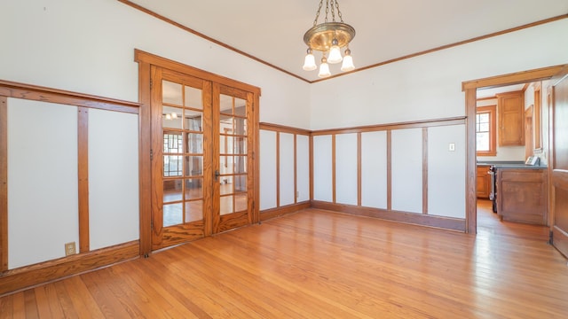 531 E Joliet St, Crown Point, IN 46307 - unfurnished room featuring french doors, light wood-style flooring, a chandelier, and ornamental molding