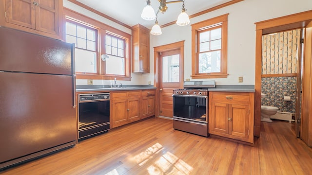 531 E Joliet St, Crown Point, IN 46307 - kitchen featuring freestanding refrigerator, black dishwasher, gas stove, brown cabinetry, and light wood-style flooring