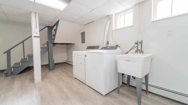 531 E Joliet St, Crown Point, IN 46307 - laundry area with washing machine and clothes dryer, light wood-style floors, electric panel, and a baseboard heating unit