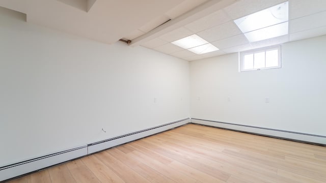 531 E Joliet St, Crown Point, IN 46307 - unfurnished room with baseboard heating, light wood-style floors, and a drop ceiling
