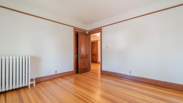 531 E Joliet St, Crown Point, IN 46307 - unfurnished room with radiator heating unit and light wood-type flooring