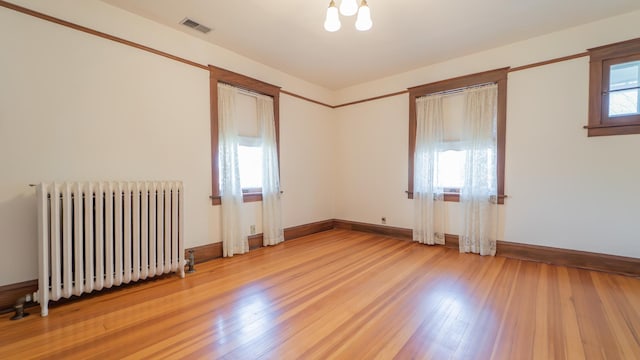 531 E Joliet St, Crown Point, IN 46307 - empty room with radiator heating unit and light wood-style flooring