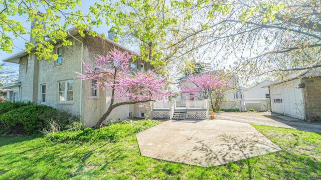 531 E Joliet St, Crown Point, IN 46307 - back of property with stucco siding, a deck, a patio, and a garage