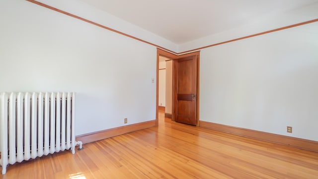 531 E Joliet St, Crown Point, IN 46307 - empty room featuring radiator and light wood-style floors