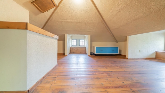 531 E Joliet St, Crown Point, IN 46307 - bonus room with hardwood / wood-style flooring, a textured ceiling, lofted ceiling, and a textured wall