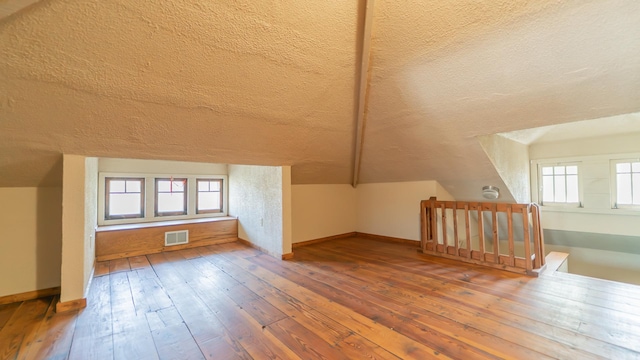 531 E Joliet St, Crown Point, IN 46307 - bonus room featuring a textured ceiling, lofted ceiling, and hardwood / wood-style flooring