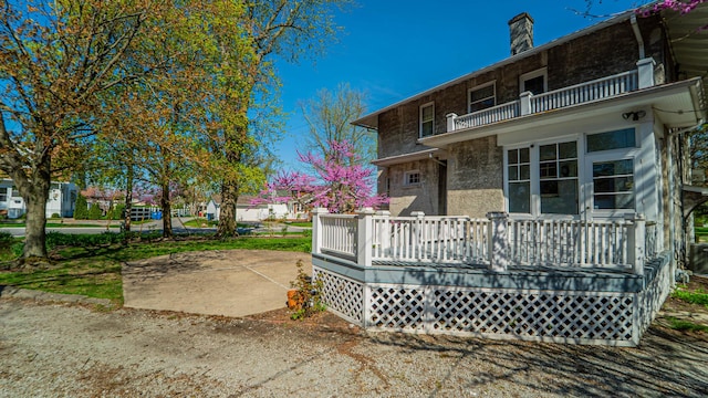 531 E Joliet St, Crown Point, IN 46307 - rear view of property featuring a balcony and a chimney