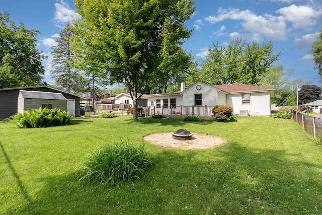 609 Oakwood Dr, Grayslake, IL 60030 - fenced backyard with an outdoor fire pit and a storage unit