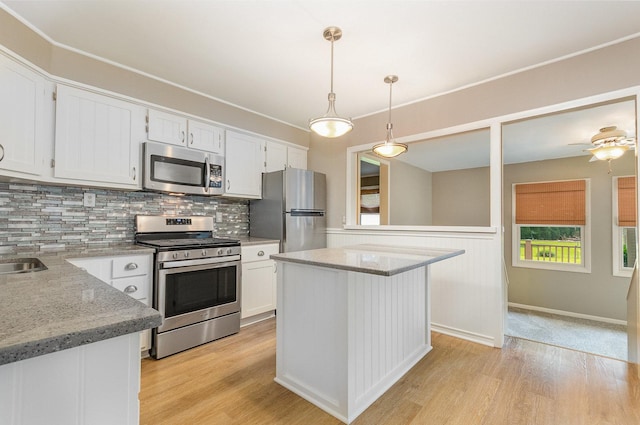 609 Oakwood Dr, Grayslake, IL 60030 - kitchen with stainless steel appliances, light wood-style flooring, white cabinets, and decorative backsplash