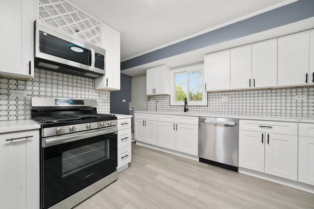 202 Allegheny St, Park Forest, IL 60466 - kitchen with appliances with stainless steel finishes, light countertops, light wood-style floors, white cabinets, and tasteful backsplash