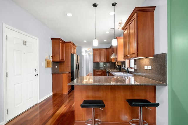 1031 N Mozart St Unit 2, Chicago, IL 60622 - kitchen with a peninsula, dark wood-style floors, brown cabinetry, and recessed lighting