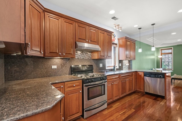 1031 N Mozart St Unit 2, Chicago, IL 60622 - kitchen with appliances with stainless steel finishes, under cabinet range hood, dark wood finished floors, a peninsula, and brown cabinets