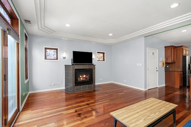 1031 N Mozart St Unit 2, Chicago, IL 60622 - unfurnished living room with a tiled fireplace, recessed lighting, wood finished floors, and a tray ceiling