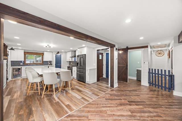 16430 S 89th Ave, Orland Park, IL 60462 - kitchen with stainless steel appliances, a barn door, beverage cooler, wood finished floors, and recessed lighting