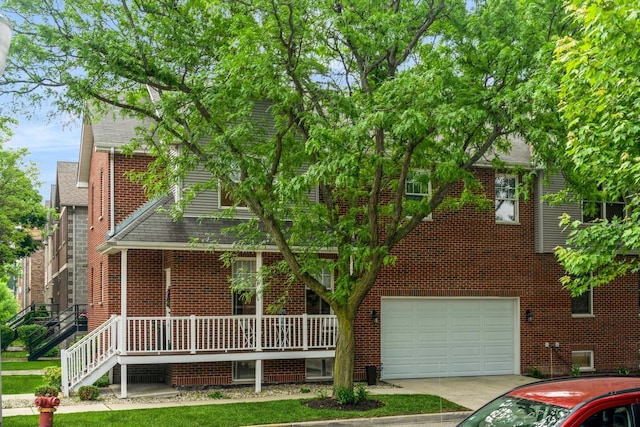835 W 37th St Unit A, Chicago, IL 60609 - view of front of home featuring an attached garage, brick siding, concrete driveway, and a shingled roof