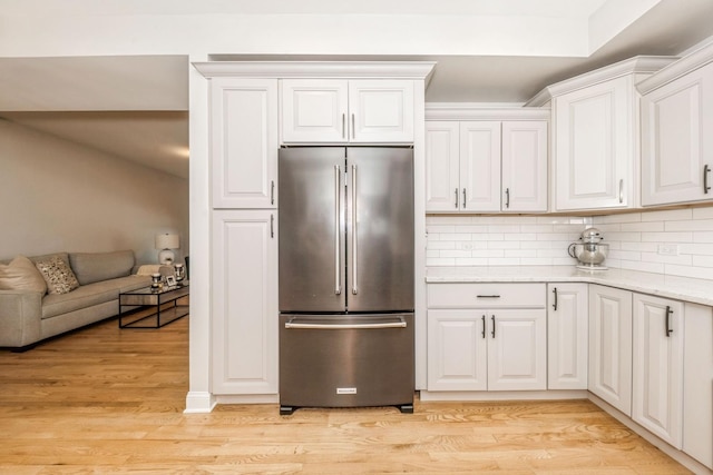 835 W 37th St Unit A, Chicago, IL 60609 - kitchen featuring high quality fridge, backsplash, light stone countertops, white cabinets, and light wood finished floors