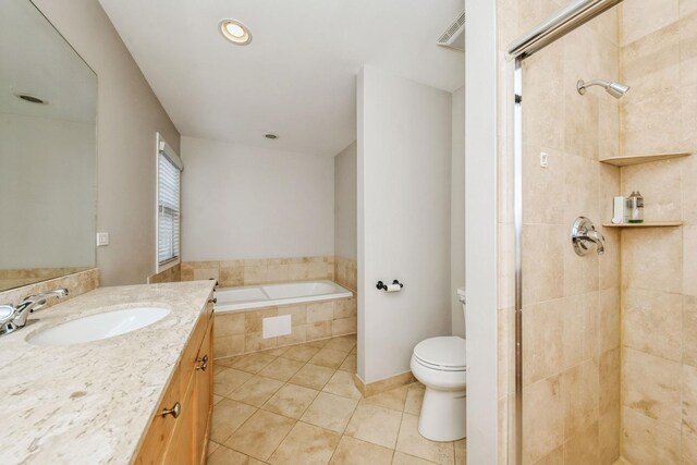 835 W 37th St Unit A, Chicago, IL 60609 - bathroom featuring tile patterned flooring, vanity, a garden tub, and a tile shower