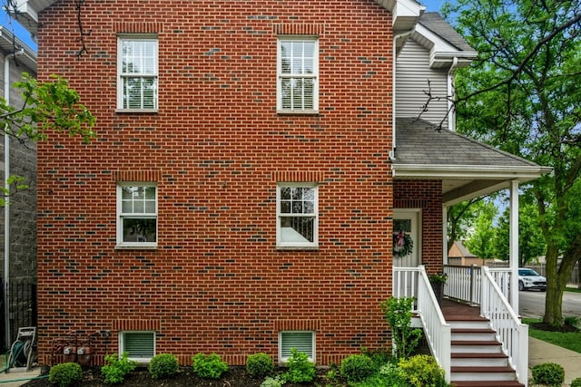 835 W 37th St Unit A, Chicago, IL 60609 - view of side of property featuring brick siding and roof with shingles