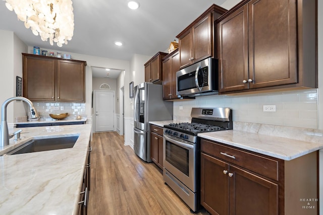 1106 Crestview Ln, Pingree Grove, IL 60140 - kitchen with stainless steel appliances, light wood-type flooring, light stone counters, dark brown cabinetry, and recessed lighting
