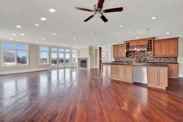 545 W Aldine Ave Unit 6E, Chicago, IL 60657 - kitchen featuring stainless steel dishwasher, open floor plan, dark countertops, a center island with sink, and dark wood finished floors