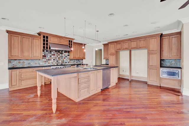 545 W Aldine Ave Unit 6E, Chicago, IL 60657 - kitchen featuring dark countertops, appliances with stainless steel finishes, backsplash, wood finished floors, and crown molding