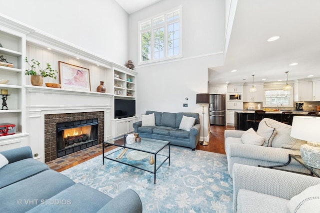571 N Main St, Glen Ellyn, IL 60137 - living area with plenty of natural light, a towering ceiling, wood finished floors, recessed lighting, and a fireplace
