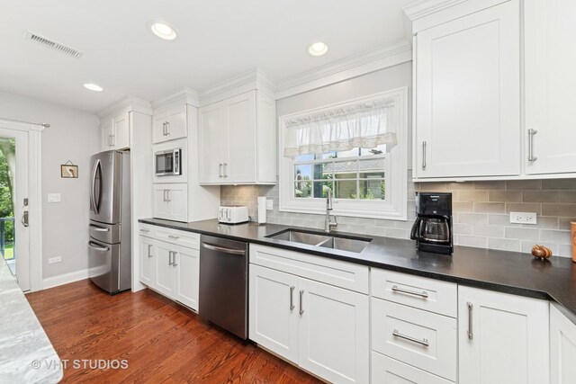 571 N Main St, Glen Ellyn, IL 60137 - kitchen with stainless steel appliances, white cabinets, backsplash, dark countertops, and recessed lighting