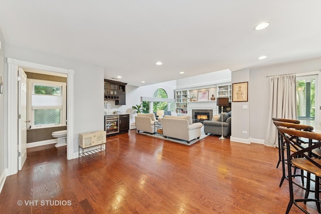 571 N Main St, Glen Ellyn, IL 60137 - living room featuring a glass covered fireplace, wine cooler, recessed lighting, and wood finished floors
