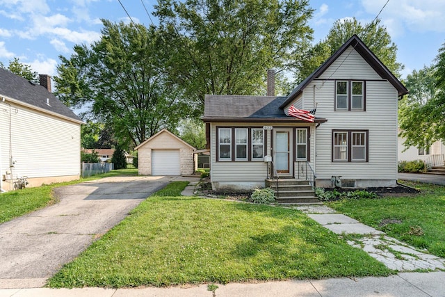 432 E Elm St, Sycamore, IL 60178 - view of front facade featuring an outbuilding, a garage, asphalt driveway, a chimney, and a front yard