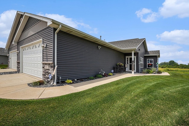3872 Stadium St, Portage, IN 46368 - view of side of home featuring a garage, a yard, driveway, and roof with shingles