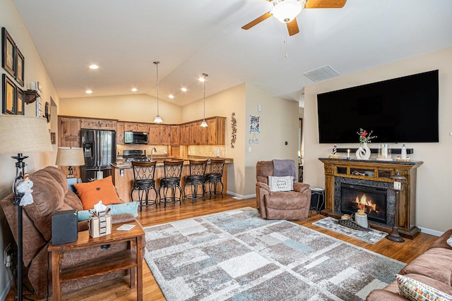 3872 Stadium St, Portage, IN 46368 - living room featuring ceiling fan, wood finished floors, lofted ceiling, a fireplace, and recessed lighting