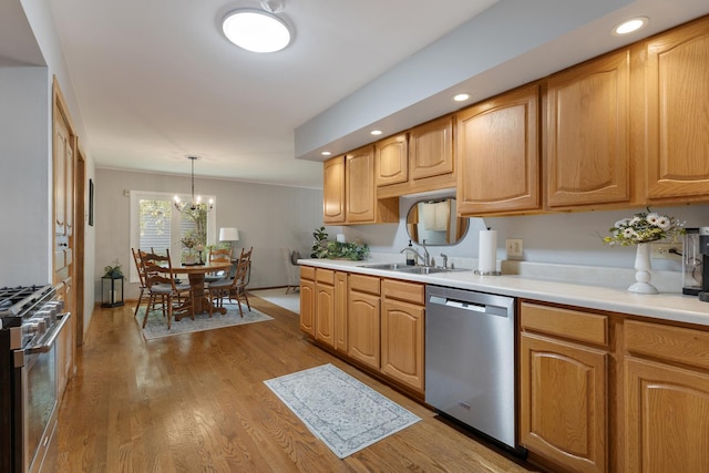 912 Eden Dr, Schaumburg, IL 60195 - kitchen with stainless steel appliances, light countertops, a chandelier, light wood finished floors, and pendant lighting