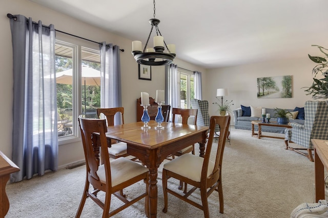 912 Eden Dr, Schaumburg, IL 60195 - dining space with light colored carpet and a chandelier