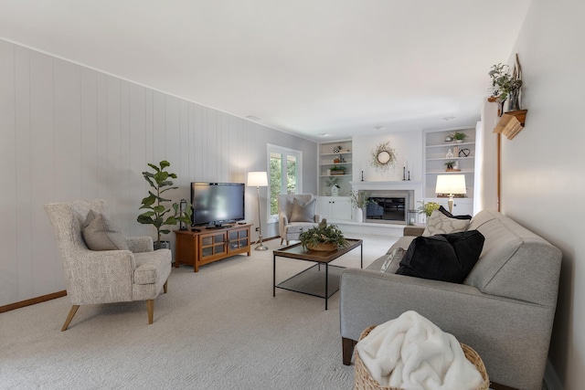 912 Eden Dr, Schaumburg, IL 60195 - living area featuring a glass covered fireplace, light colored carpet, and built in features