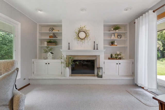 912 Eden Dr, Schaumburg, IL 60195 - unfurnished living room featuring built in features, carpet floors, and a glass covered fireplace