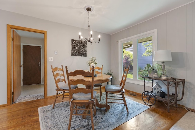 912 Eden Dr, Schaumburg, IL 60195 - dining room featuring light wood-type flooring and a chandelier