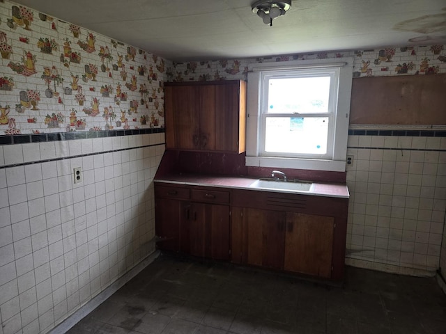 101 Vine St, Ludlow, IL 60949 - kitchen with tile walls, a wainscoted wall, wallpapered walls, dark tile patterned flooring, and tile countertops