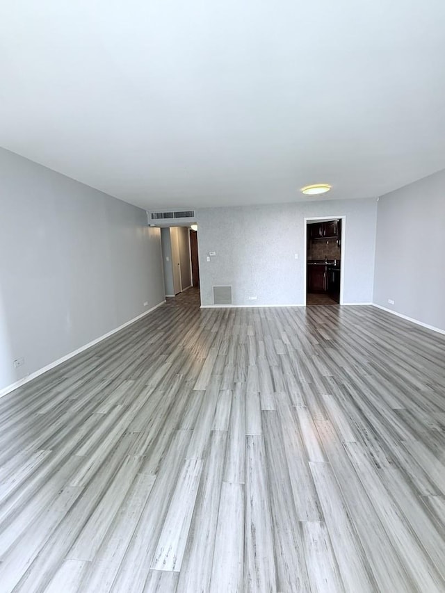 6033 N Sheridan Rd Unit 11L, Chicago, IL 60660 - unfurnished living room featuring wood finished floors and baseboards