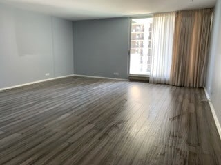 6033 N Sheridan Rd Unit 11L, Chicago, IL 60660 - unfurnished room featuring baseboards and dark wood-style flooring