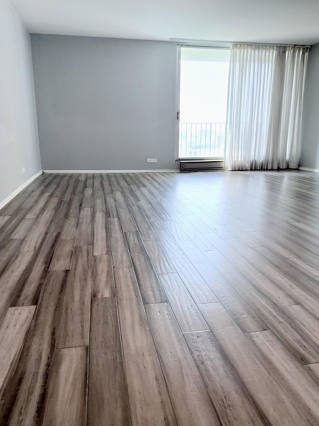 6033 N Sheridan Rd Unit 11L, Chicago, IL 60660 - empty room featuring wood finished floors and baseboard heating