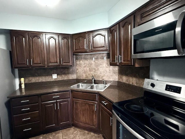 6033 N Sheridan Rd Unit 11L, Chicago, IL 60660 - kitchen with stainless steel appliances, backsplash, dark brown cabinets, and dark countertops