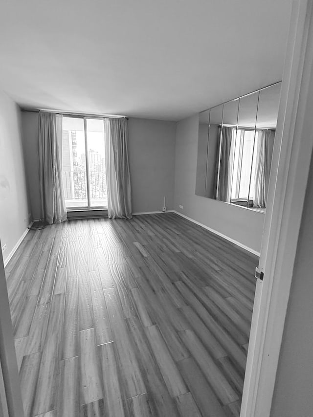 6033 N Sheridan Rd Unit 11L, Chicago, IL 60660 - unfurnished room with dark wood-style floors and baseboards