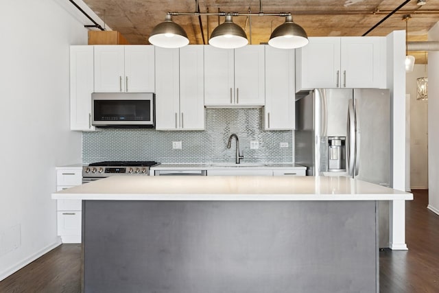 6 S Laflin St Unit 607, Chicago, IL 60607 - kitchen featuring stainless steel appliances, a kitchen island, dark wood-style floors, decorative backsplash, and light countertops