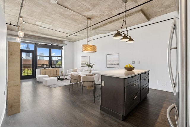 6 S Laflin St Unit 607, Chicago, IL 60607 - kitchen featuring freestanding refrigerator, dark wood-style flooring, light countertops, decorative light fixtures, and a kitchen breakfast bar