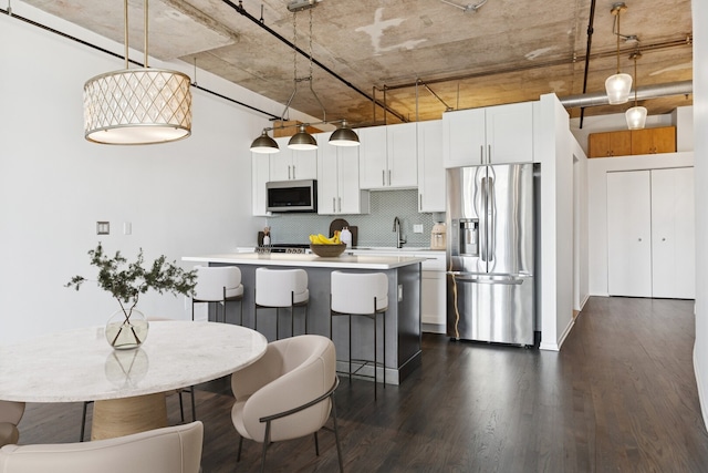 6 S Laflin St Unit 607, Chicago, IL 60607 - kitchen featuring appliances with stainless steel finishes, decorative backsplash, dark wood-type flooring, and light countertops